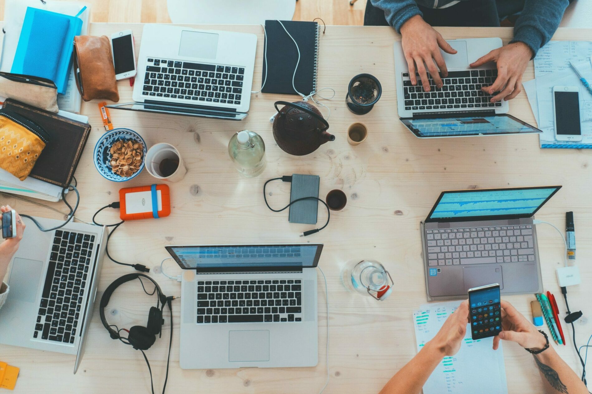 Birdseye view of a table of people working on laptops