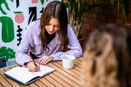 Izzy, our UX services specialist working with pen and paper starting the UX design process