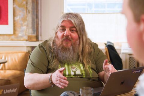 Pete, Unfolds senior technician using his hands to explain Laravel