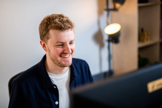 Photo of Harry, MD of Unfold looking at his computer screen.